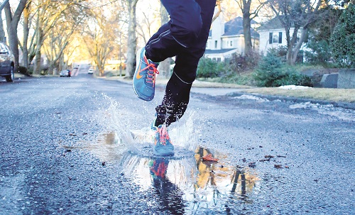 Stephen Barbieri finds a puddle on his morning run. Photo: Gabriella Meglasson
