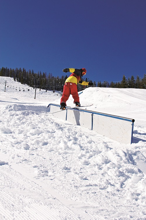 Snowboarder riding a rail in a terrain park at Lookout Pass. Photo courtesy: Lookout Pass Ski and Recreation Area