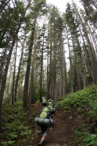 Peak 7 youth hiking through the woods on a multi-day backpacking adventure. Photo: Tucker Walker