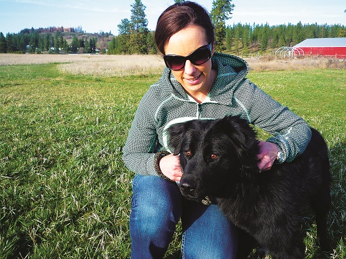 Susan is getting to know Baby, a 3 year old lab/chow mix, at the Spokane Humane Society. Photo: Brad Naccarato