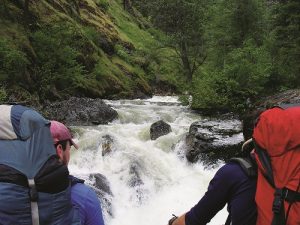 Looking over the shoulders of Kit and Alex at the raging Wind River. Photo: Derrick Knowles