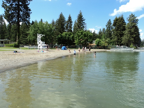 Honeysuckle Beach near Hayden, Idaho is great because it has it all – certified lifeguards, restrooms, a kid-friendly food concession, dock, beautiful mountain views, and blue-looking lake water. Photo courtesy Travelcoeurdalene.com