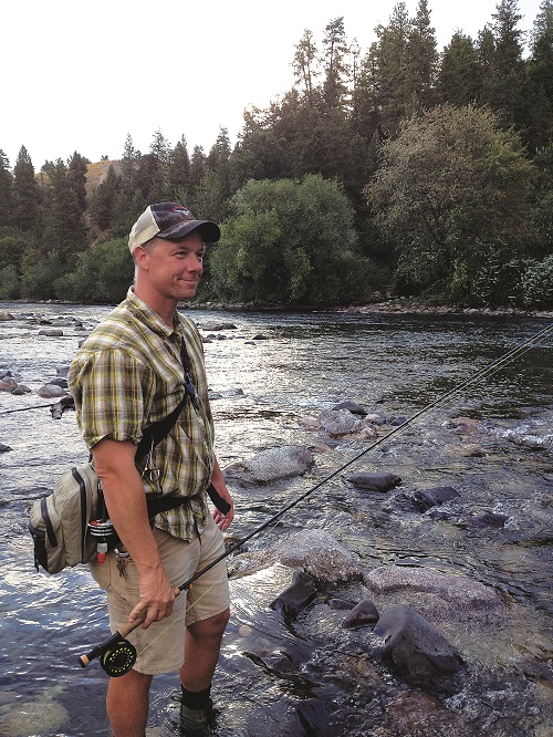 Jerry White calf deep in the Spokane, casting for redbands. Photo: Derrick Knowles