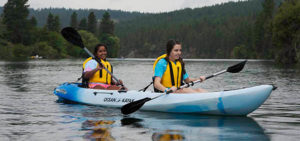 Photo of two girls kayaking on the Spokane River.