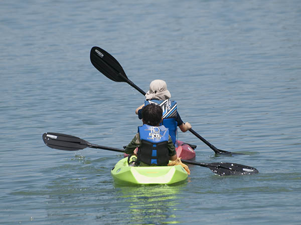 Photo of two young children in a kayak.