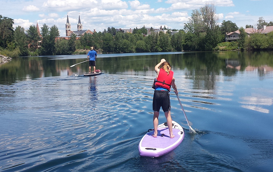 Photo of paddleboarders on the Spokane River by Cara Quien.
