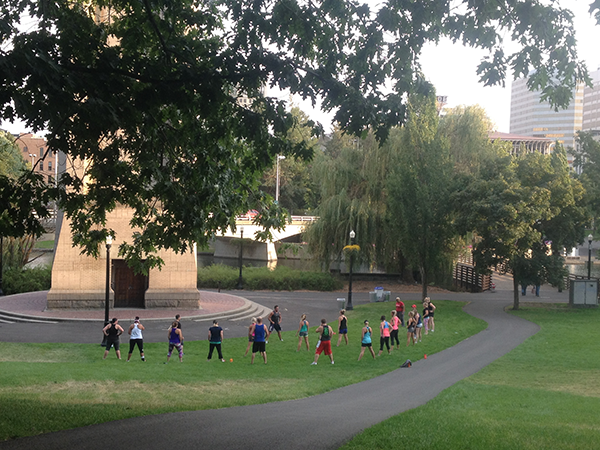Photo of outdoors yoga class in the park by Derrick Knowles.