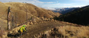 Photo of biker on trail through Hells Canyon.