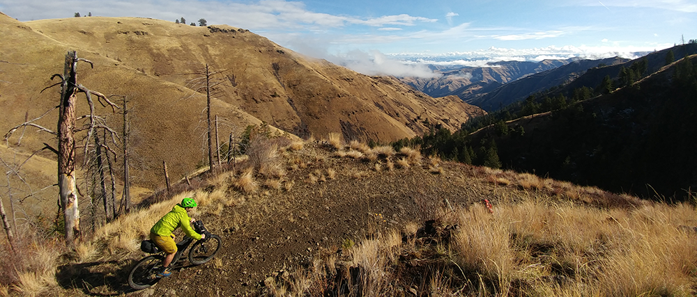 Photo of biker on trail through Hells Canyon.