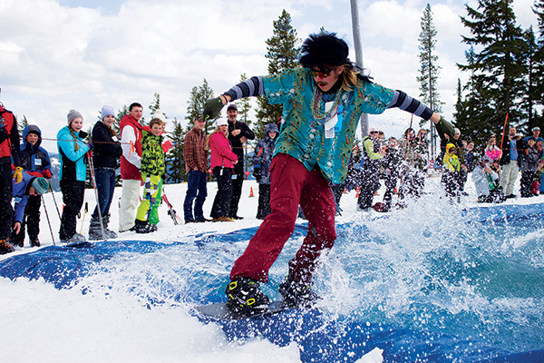 Snowboarder in costume skimming across the pond.