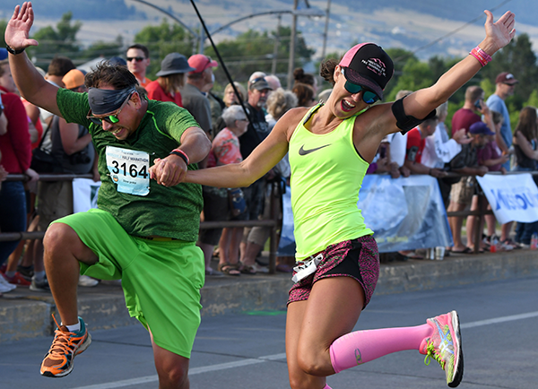 Photo of runners jumping at finish line.