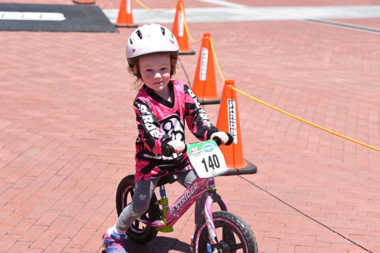 kid on strider bike