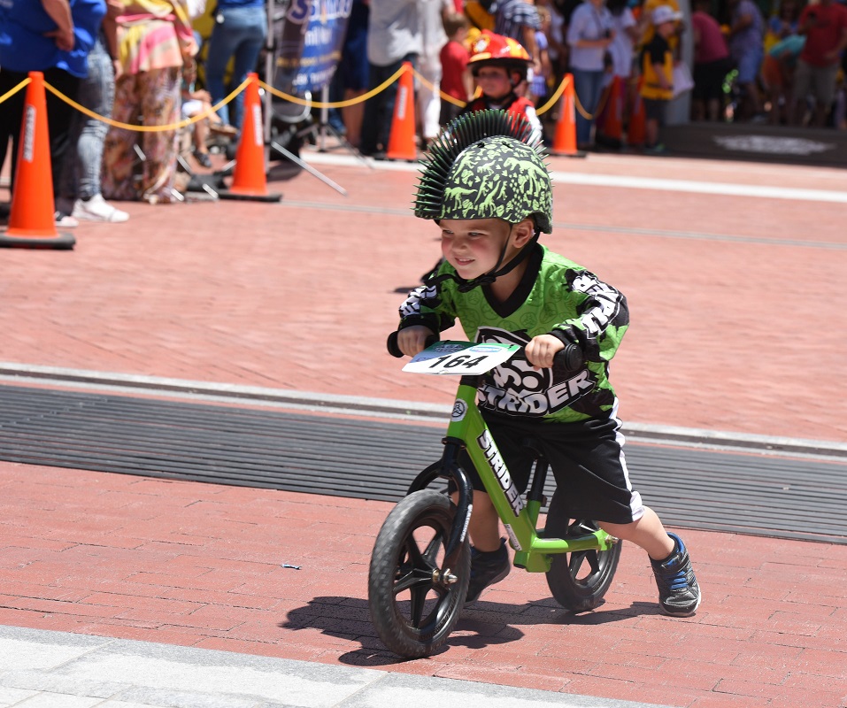 kid riding strider bike