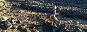 Photo of Sarah Oscarson running across Mt. St. Helens blast zone.