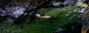 Photo of whitewater kayaker from above.