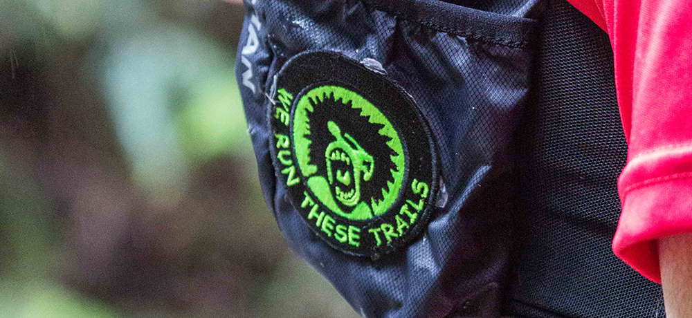 Close up photo of Trail Maniacs patch on backpack.