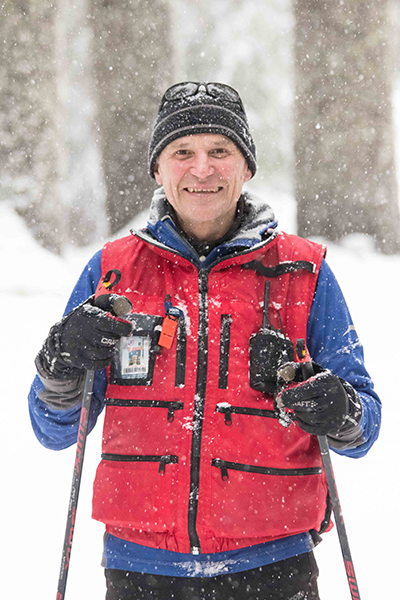 Candid shot of Ranger Steve Christensen holding employee pass.