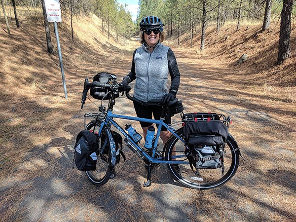 Photo of Kathy Greer and bike in Riverside State Park.