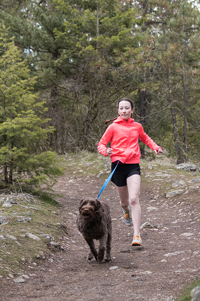 Photo of Lauren West running with dog.