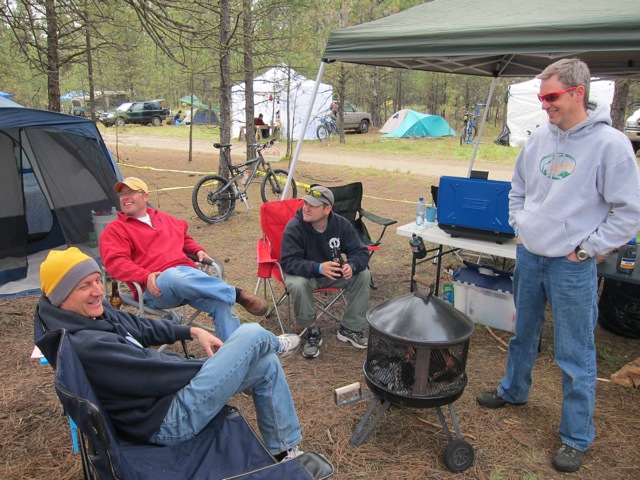 Four men from team Patriot Fire sit in camp chairs while waiting for the race to start. 