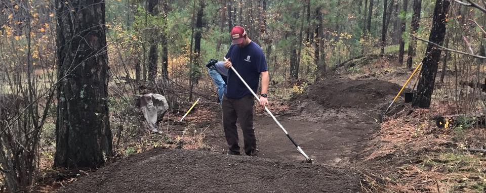 Photo of Evergreen East member completing trail maintenance.