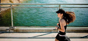 Photo of runner on bridge over the Spokane River.