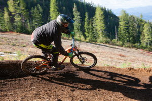 Mountain biking navigating a turn at Silver Mountain Bike Park.