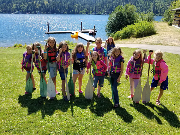 Photo of girls on lake shore.