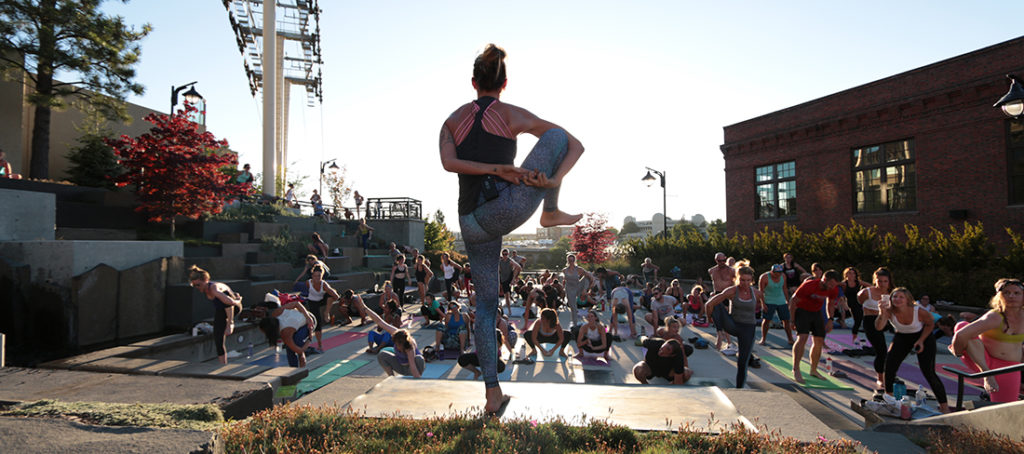 Photo of yoga instructor and crowd at Riverfront Park.