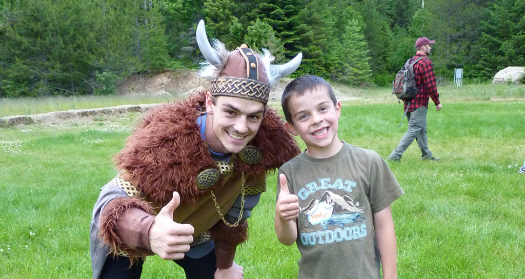 Camper is all smiles with the Biking costumed recreation leader.