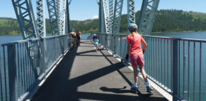 Photo of kids rollerblading across bridge.