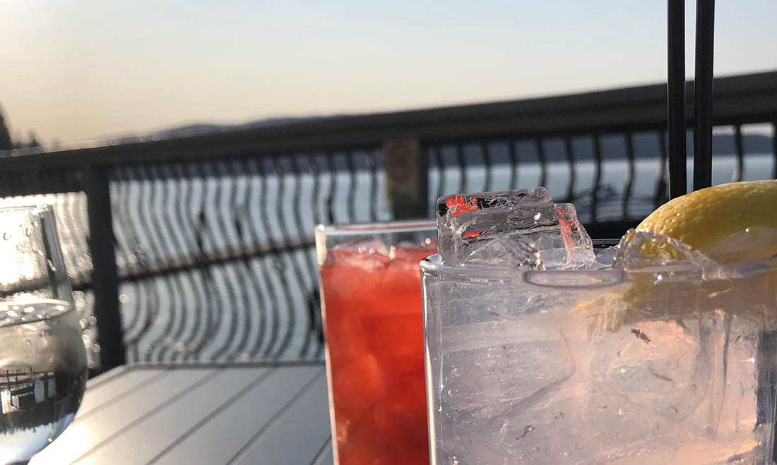 Photo of drinks on a dining table overlooking Lake Coeur d'Alene.