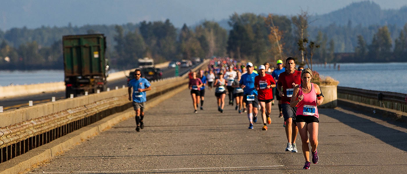 Photo of runners crossing a bridge during the Sandpoint Scenic Half.