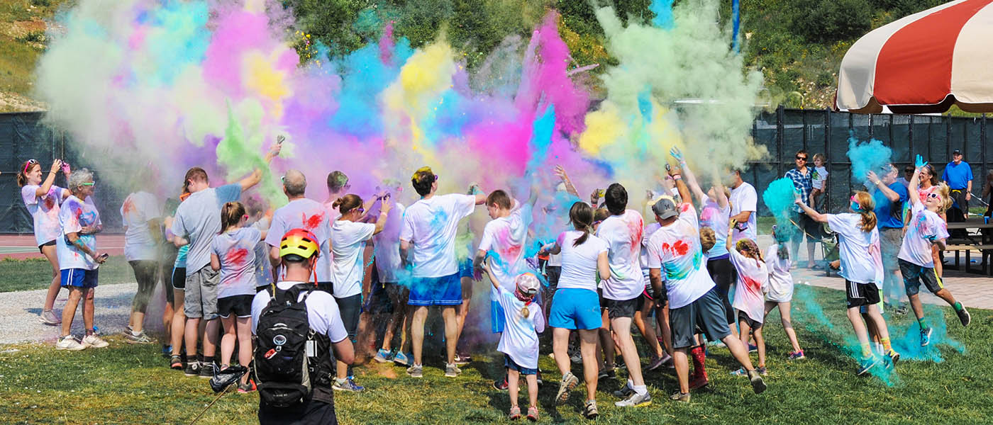 Photo of the Hukleberry Fun Run participants grouped around an explosion of colored powder.