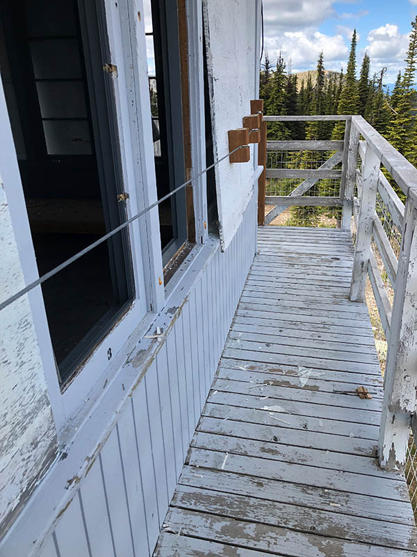 Photo of broken windows on a fire lookout tower.