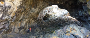 Photo of kids exploring lava tubes from above.