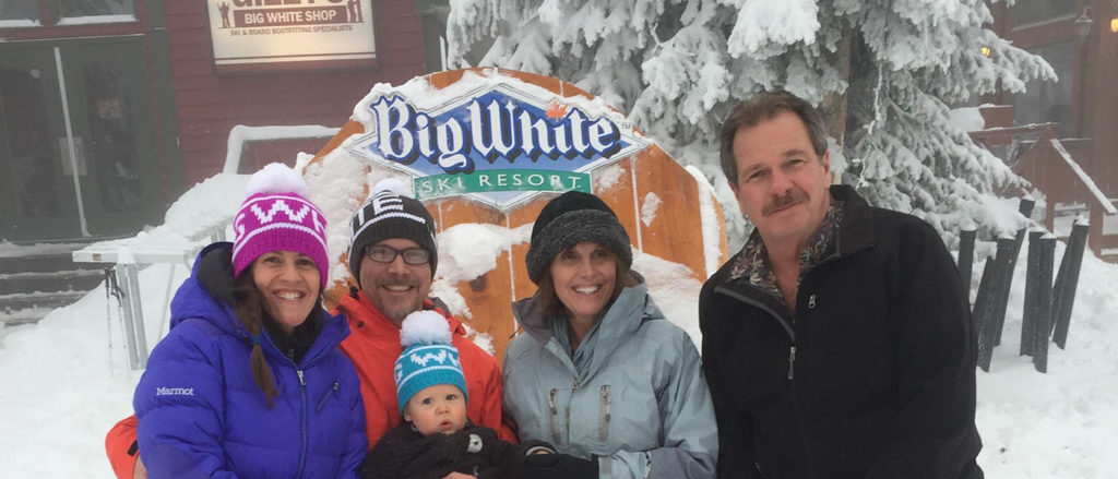 Photo of OTO publishers, Shallan & Derrick Knowles with family posing in front of Big White sign.