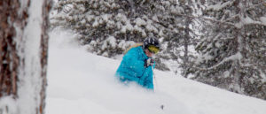 Photo of Kelli Christopherson skiing powder at Lookout Pass.