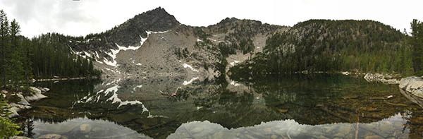 Panorama of West Oval Lake with mountains in the background.