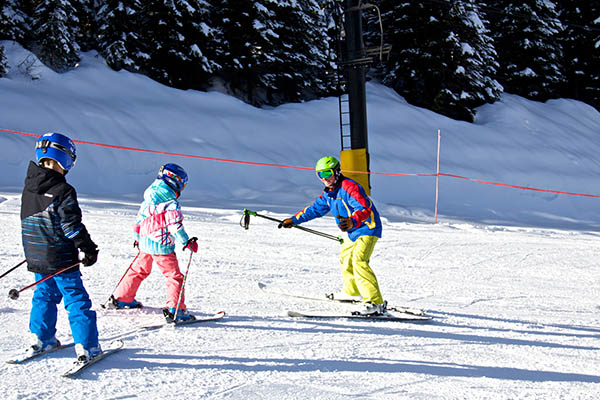 An instructor leading two students down the beginner hill at Lookout Pass.