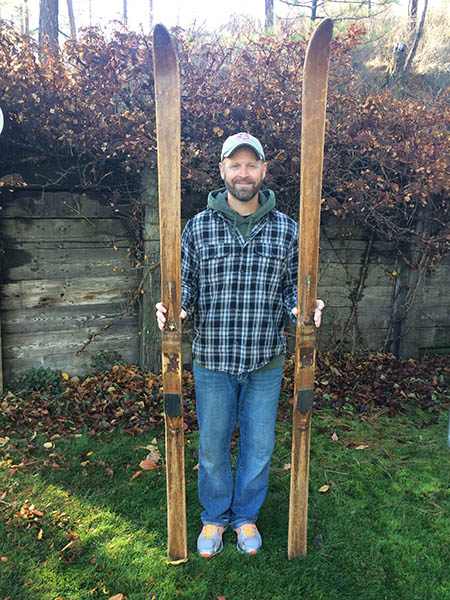 Photo of the author, Brad Northrup holding his wooden skis.