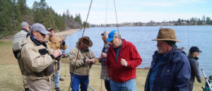 Fly Fishing Students talking on lakeshore.