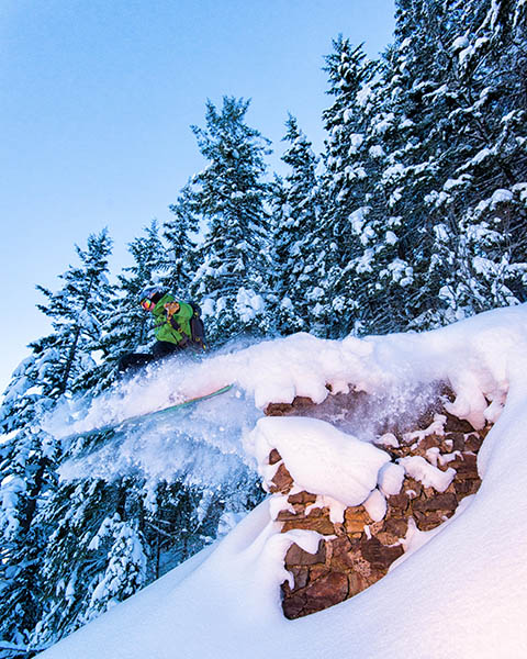 Photo of a skier catching air off of an old mine entrance.