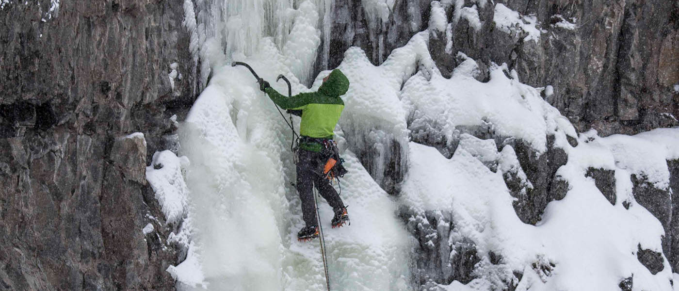 Photo of ice climber assessing route.