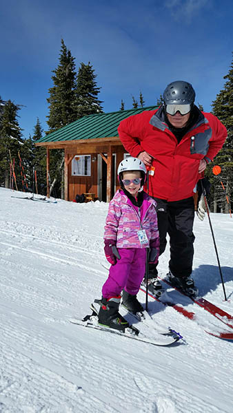 Photo of Doug and his granddaughter, Gabby on skis.