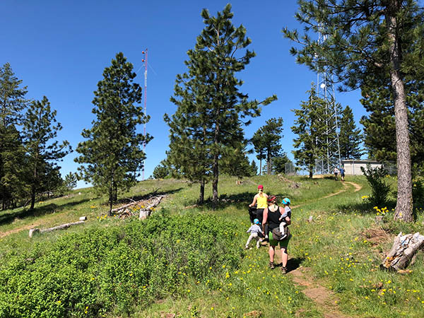 Photo of family hiking to cell tower marking the summit of Antoine Peak.