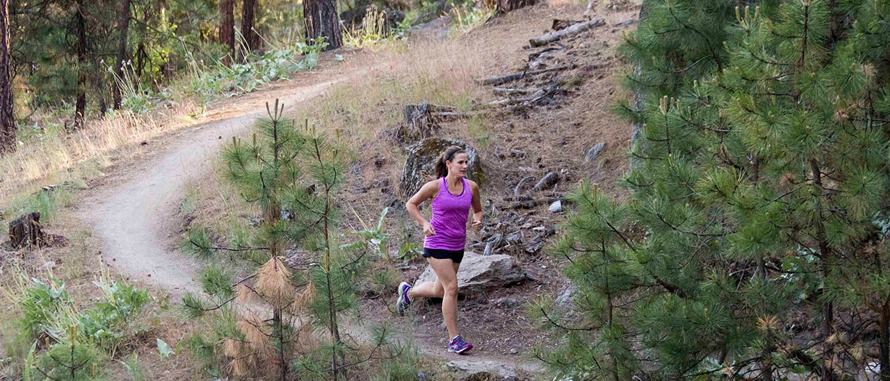 Photo of runner on single track trail.