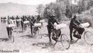 Vintage photo of 25th Regiment -- African-American soldiers -- riding bikes in Wallace, Idaho.