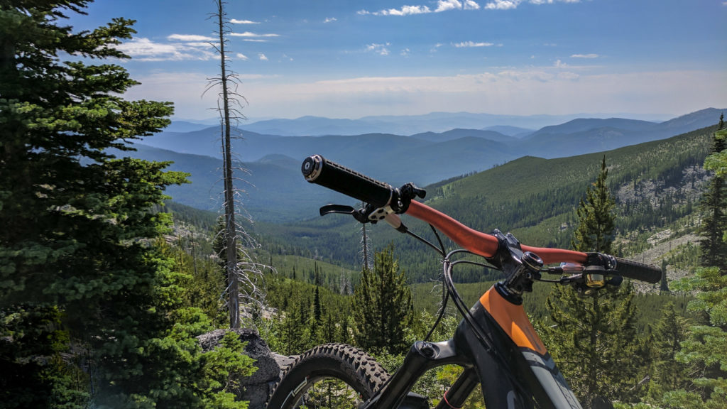 Mountain bike on a trail in the Colville National Forest with a view of the Kettle Crest Range.