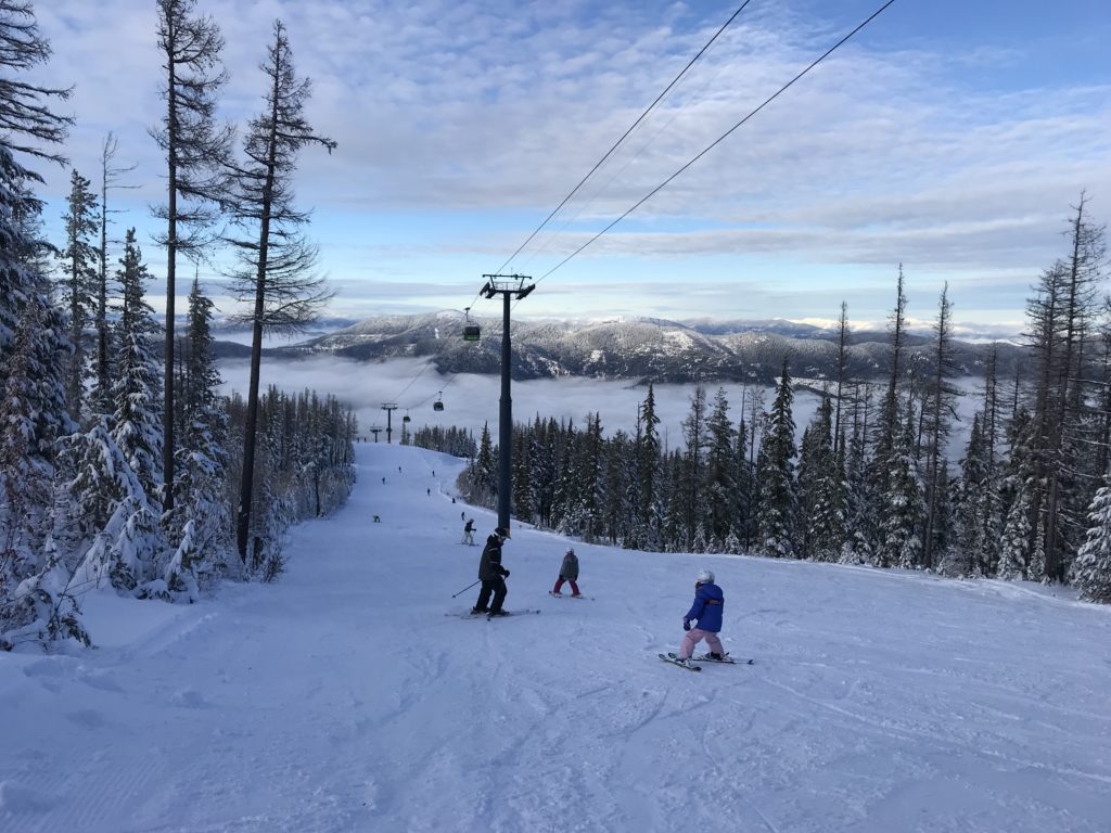 Dads and daughter down a slope at Silver Mountain Resort.
